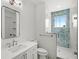 Modern bathroom featuring a glass shower, a window, a mirror, and chrome fixtures at 102 Hammock Preserve Loop, Winter Garden, FL 34787