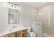 Modern bathroom with wood vanity, glass shower with chevron tile, and stylish light fixtures at 102 Hammock Preserve Loop, Winter Garden, FL 34787