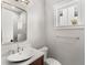 Stylish bathroom featuring a marble countertop, updated fixtures, and natural light from the window at 102 Hammock Preserve Loop, Winter Garden, FL 34787
