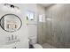 Modern bathroom featuring a stylish vanity, bright shower, and updated light fixture at 102 Hammock Preserve Loop, Winter Garden, FL 34787