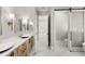 Bright bathroom featuring dual sinks and barn door to the commode at 102 Hammock Preserve Loop, Winter Garden, FL 34787