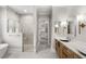 Modern bathroom featuring dual sinks, soaking tub, and glass enclosed shower at 102 Hammock Preserve Loop, Winter Garden, FL 34787