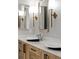 Close up of the dual sinks, lighting, and mirrors in the bathroom at 102 Hammock Preserve Loop, Winter Garden, FL 34787