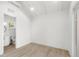 Bright bedroom with light wood floors, a walk in bathroom, and modern trim details at 102 Hammock Preserve Loop, Winter Garden, FL 34787