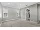 Bright bedroom featuring a ceiling fan, plush carpet, neutral walls, and bathroom access at 102 Hammock Preserve Loop, Winter Garden, FL 34787