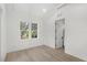 Bright bedroom with light wood floors, a large window, and modern trim details at 102 Hammock Preserve Loop, Winter Garden, FL 34787