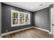 Neutral bedroom featuring hardwood floors and bright window overlooking a green space at 102 Hammock Preserve Loop, Winter Garden, FL 34787