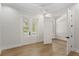 Bright, empty bedroom with hardwood floors and double doors at 102 Hammock Preserve Loop, Winter Garden, FL 34787
