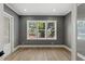 Neutral bedroom featuring hardwood floors and bright window overlooking the neighborhood at 102 Hammock Preserve Loop, Winter Garden, FL 34787