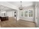 Dining room showcases wood floors, a statement chandelier, and bright windows that add natural light to the space at 102 Hammock Preserve Loop, Winter Garden, FL 34787