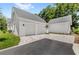 Spacious driveway leading to a pristine home exterior featuring a multi-car garage and well-maintained landscaping at 102 Hammock Preserve Loop, Winter Garden, FL 34787