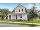 Charming two-story home boasting a welcoming front porch and meticulously maintained landscaping adding to its allure at 102 Hammock Preserve Loop, Winter Garden, FL 34787