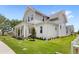 Charming two-story home with a manicured lawn and inviting front porch, showcasing classic architectural details at 102 Hammock Preserve Loop, Winter Garden, FL 34787