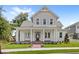 Inviting two-story home with a classic front porch and well-manicured lawn offering great curb appeal at 102 Hammock Preserve Loop, Winter Garden, FL 34787