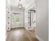 Bright foyer with wood floors and decorative glass front door, showcasing style and elegance at 102 Hammock Preserve Loop, Winter Garden, FL 34787