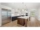 Modern kitchen featuring stainless steel appliances, a center island, and custom cabinetry creating a functional space at 102 Hammock Preserve Loop, Winter Garden, FL 34787