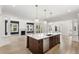 Open kitchen features an island with modern sink and stainless steel dishwasher, and overlooks the living room at 102 Hammock Preserve Loop, Winter Garden, FL 34787
