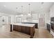 Modern kitchen showcasing stainless steel appliances, a center island, and custom cabinetry creating a delightful space at 102 Hammock Preserve Loop, Winter Garden, FL 34787