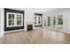 Living room boasts a brick fireplace and glass doors, blending comfort and style at 102 Hammock Preserve Loop, Winter Garden, FL 34787