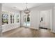 Brightly lit living room with French doors and big windows at 102 Hammock Preserve Loop, Winter Garden, FL 34787