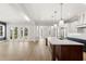 Spacious living room with wood floors, fireplace, and glass doors that provide a bright and airy atmosphere at 102 Hammock Preserve Loop, Winter Garden, FL 34787