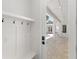 Bright mudroom featuring built in bench and storage, access to the outdoor patio and pool at 102 Hammock Preserve Loop, Winter Garden, FL 34787