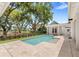 Backyard pool featuring a travertine patio and a tranquil setting with lush landscaping and privacy fencing at 102 Hammock Preserve Loop, Winter Garden, FL 34787
