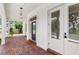 Inviting front porch featuring brick flooring and elegant architectural details offering a warm welcome to the home at 102 Hammock Preserve Loop, Winter Garden, FL 34787