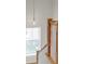 Staircase with wood railing and pendant light, showcasing natural light at 102 Hammock Preserve Loop, Winter Garden, FL 34787