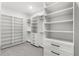 Spacious walk-in closet with custom shelving and drawers providing ample storage at 102 Hammock Preserve Loop, Winter Garden, FL 34787