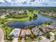 Aerial view of home and its location on the lake, surrounded by mature landscaping at 106 Winghurst Blvd, Orlando, FL 32828