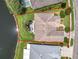 Aerial view of home showcasing the lot, screened-in patio, and proximity to the lake at 106 Winghurst Blvd, Orlando, FL 32828