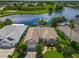 Aerial view of single Gathering home with lush landscaping, water view, and pool at 106 Winghurst Blvd, Orlando, FL 32828