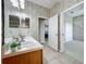 Tile bathroom with double sinks, vanity, and doorway to another room at 106 Winghurst Blvd, Orlando, FL 32828
