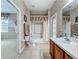 Tiled bathroom leading to the carpeted bedroom offers a shower-tub combination and vanity at 106 Winghurst Blvd, Orlando, FL 32828