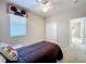 Cozy bedroom features a double bed, ceiling fan, window, and double door closet at 106 Winghurst Blvd, Orlando, FL 32828