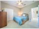 Bright bedroom with a ceiling fan, double-door closet, and an adjacent doorway at 106 Winghurst Blvd, Orlando, FL 32828