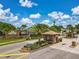 Community entrance with brick gatehouse, manicured landscaping, and secure entry gates at 106 Winghurst Blvd, Orlando, FL 32828