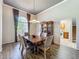 Dining room with a wood table, six chairs, wood floors, chandelier and a china cabinet at 106 Winghurst Blvd, Orlando, FL 32828