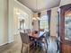 Traditional dining room features a wood table, six chairs, wood floors and an elegant light fixture at 106 Winghurst Blvd, Orlando, FL 32828