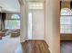 View of Foyer with wood-look floors, transom windows and sightlines into the Living Room at 106 Winghurst Blvd, Orlando, FL 32828