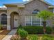 Close up of front door with decorative wreath and beautiful brick accents at 106 Winghurst Blvd, Orlando, FL 32828