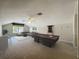 Spacious game room featuring a pool table, wet bar, and comfortable seating area at 106 Winghurst Blvd, Orlando, FL 32828
