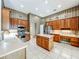 Kitchen featuring stainless steel appliances, wood cabinets and a breakfast island overlooking a breakfast nook at 106 Winghurst Blvd, Orlando, FL 32828