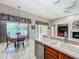 Kitchen featuring wood cabinets and stainless steel appliances open to breakfast nook and living room at 106 Winghurst Blvd, Orlando, FL 32828