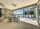 Covered lanai with dining set overlooking lake views at 106 Winghurst Blvd, Orlando, FL 32828