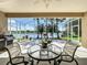 Screened in lanai with a table set overlooking a scenic lake view at 106 Winghurst Blvd, Orlando, FL 32828