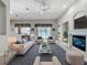 Bright living room featuring vaulted ceilings, a cozy fireplace, and access to the outdoor space at 106 Winghurst Blvd, Orlando, FL 32828