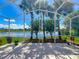 Screened patio with lake view surrounded by lush green trees at 106 Winghurst Blvd, Orlando, FL 32828