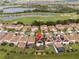 Beautiful aerial view of a neighborhood with lush golf course, and lovely water features in the background at 1097 Trappers Trail Loop, Davenport, FL 33896